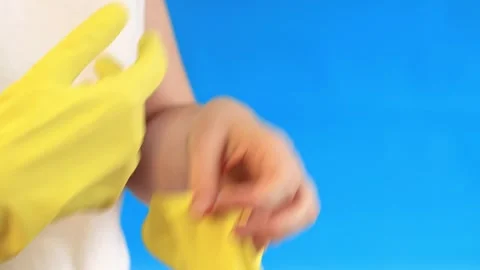 Put gloves on your hands, blue background Stock Footage 262163735