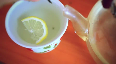 Put green tea in cup with  slice of lemon and teapot Stock Footage 52953435