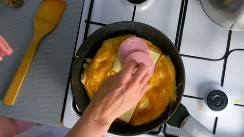 Put ham on processed cheese on frying bread for sandwich with egg on skillet . Video stock 318215659