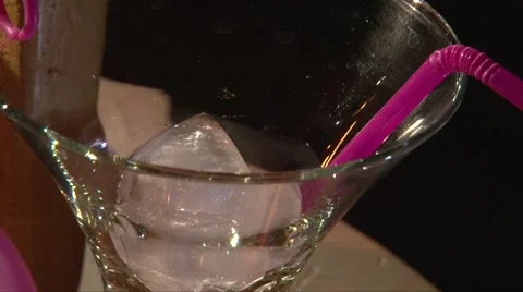 Put ice cubes into the glass and pouring red drink in it, closeup shot Stock Footage 68213219