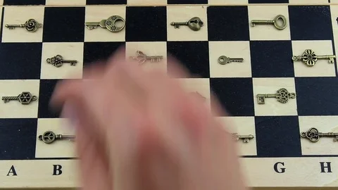 To put a key on a chessboard Stock Footage 79640142