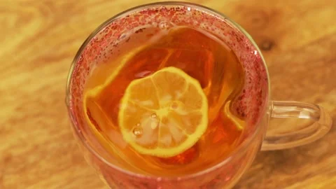 Put a Lemon Slice in Cup of Tea, close-up. Stock Footage 166092732