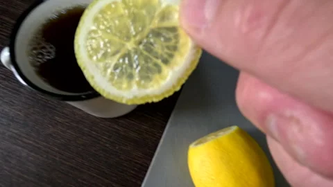 Put lemon to tea mug Stock Footage 247556608