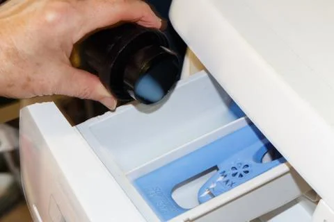Put liquid detergent in the washing machine Stock Photos