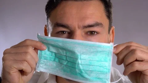 Put the mask, close up portrait of a surgeon or doctor with mask and headset Stock Footage 101792244
