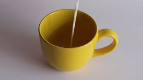 Put the milk to yellow cup Stock Footage 134278092