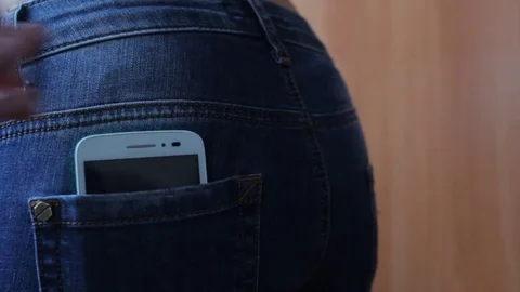 Put mobile phone into pocket Stock Footage 73610183