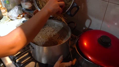 Put noodles into a kitchen pot preparing arabic rice Stock Footage 146000300