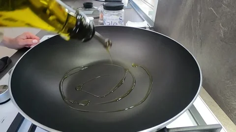 Put oil in the pan, in the home kitchen Stock Footage 145875755