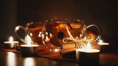 Put out candles surrounding in apple Cider Drink, Juice, Punch, Tea with Spic Stock-Footage 121583583