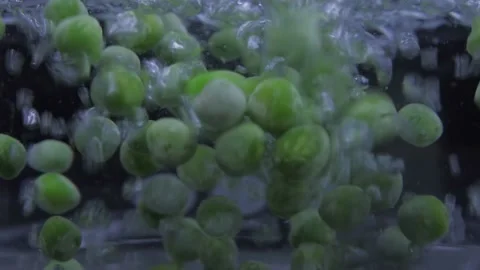 Put peas on boiling water pot slow motion 4k Video stock 149672428