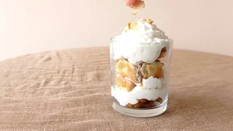 Put a piece a cake into the top of the chocolate cake Stock Footage 145673970