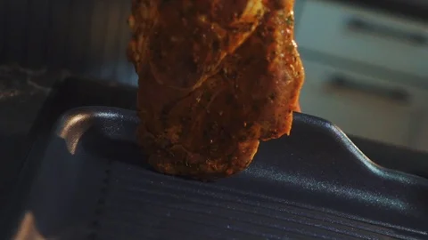 Put a piece of steak meat on a grill pan and camera goes like a b-roll style Stock Footage 125064218