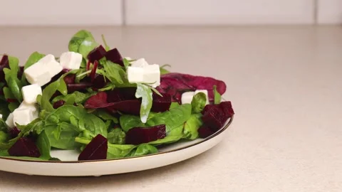 Put a plate of salad with boiled beef and feta cheese on the table Stock Footage 281089615