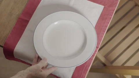 Put plates on table for dinner Stock Footage 336240562