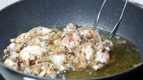 Put raw fried leg chicken  into boiled food palm oil Stock Footage 89513776