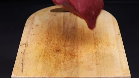 Put raw meat on a cutting board Stock Footage 126573610