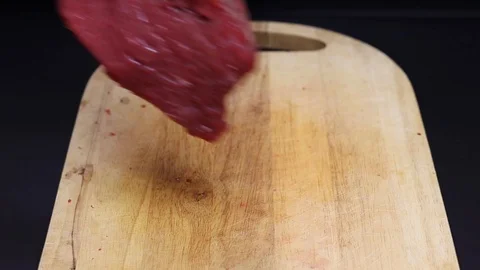 Put raw meat on a cutting board Stock Footage 126573621