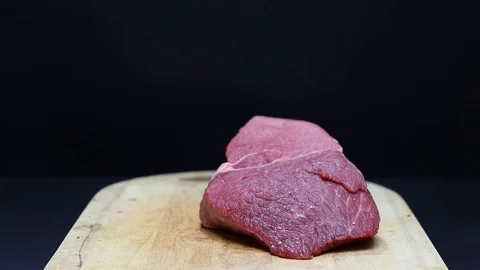 Put raw meat on a cutting board Stock Footage 126573625