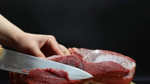 Put raw meat on a cutting board Stock Footage 126573664