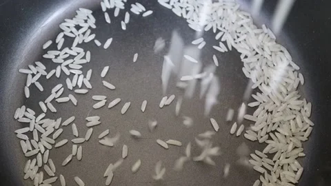Put raw rice into the electric rice cooker to boiled and eating Stock Footage 149362359