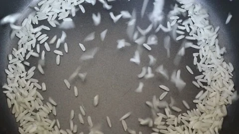 Put raw rice into electric rice cooker to boiled and hand cheking Stock Footage 149362407
