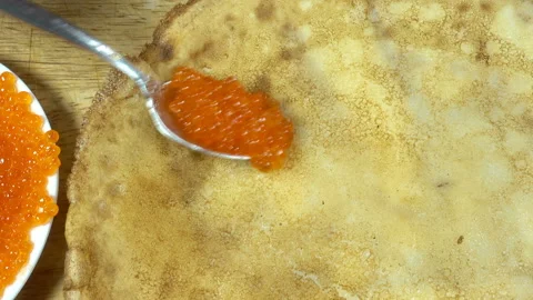 Put red caviar on a pancake and wrap Stock Footage 132100178