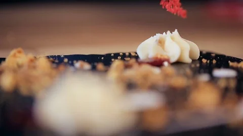 Put a red element on creamy star of chocolate Dessert in a restaurant Video stock 75354898