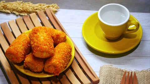 Put the risol into the plate on the table Stockbeeldmateriaal 215632127