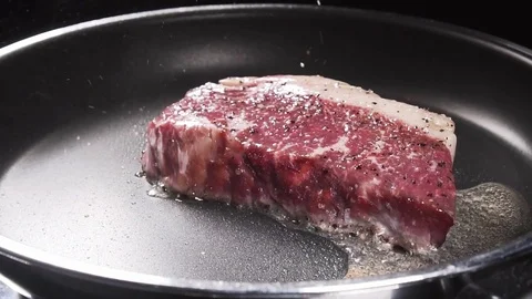 Put rosemary on a steak Stock Footage 84778724