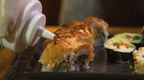 Put Sauceon a sush roll Video stock 66529794