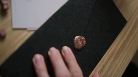 Put the seal on the hot wax on the envelope. Paraffin printing. Blur. Selective  Stock Footage 147546379