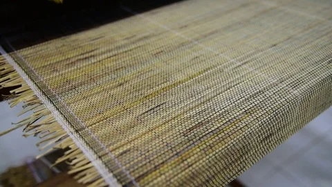 Put shuttle on the weaved material with straws Stock Footage 71199399