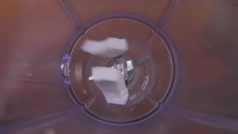 Put sliced coconut into blender 4k Stock Footage 149629729