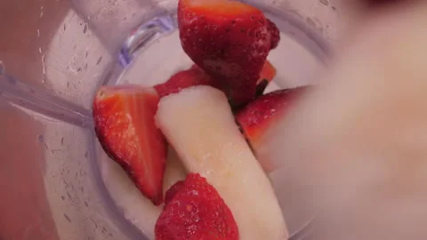 Put sliced fruit into blender slow motion 4k Stock Footage 149677544