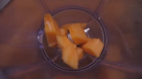 Put sliced melon into blender slow motion Stock Footage 149718429