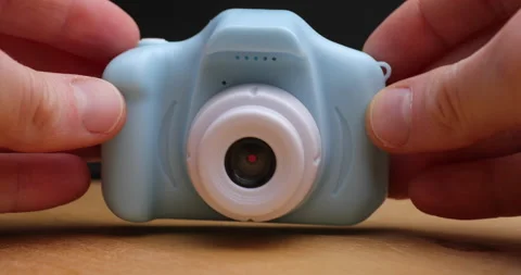 Put small toy camera on table Stock Footage 156859381