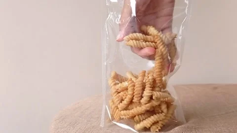 Put some snack into a plastic bag Stock Footage 146246933