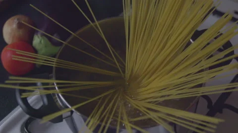 Put spaghetti into boiling water Stock Footage 57638854