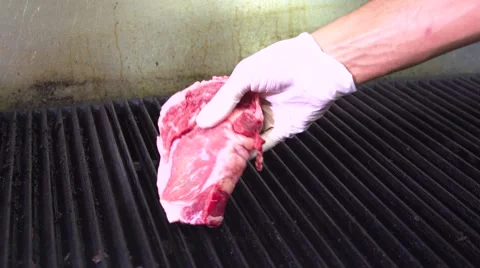 Put a Steak on the grill. Stock Footage 66698648