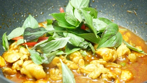 Put sweet basil , bell pepper into the black teflon pan which stir fried chic Stock Footage 89498855