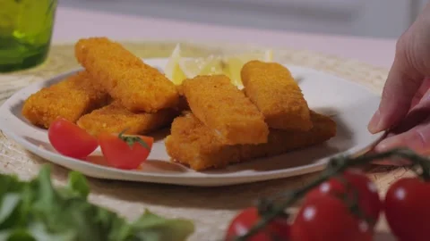 Put on the table a dish of fry fish sticks.tasty seafood, crispy fried fillets o Stock Footage 234281930