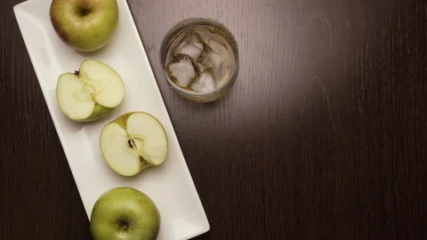Put on the table a glass of whiskey, put ice. top view Stock Footage 73798312