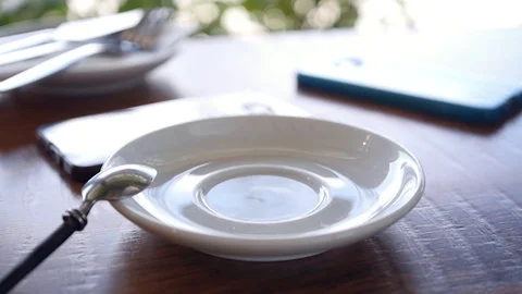 Put on the table a white cup of invigorating hot latte. HD, 1920x1080, slow Stock Footage 96610663