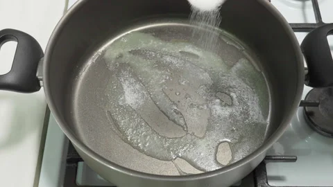 Put a tablespoon of sugar in a pan with melted butter Stock Footage 232408084