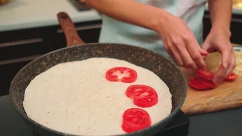 Put thin rings of ripe tomato on top of pita bread Stock-Footage 252179997