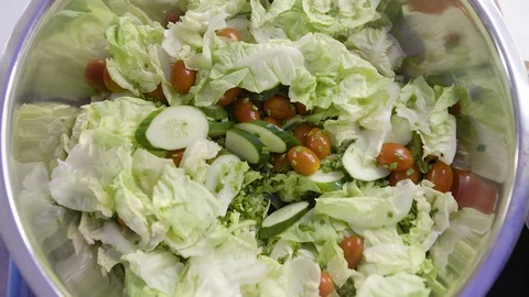 Put Tomato into Mixed Variety Vegetables Bowl Stock Footage 128678583