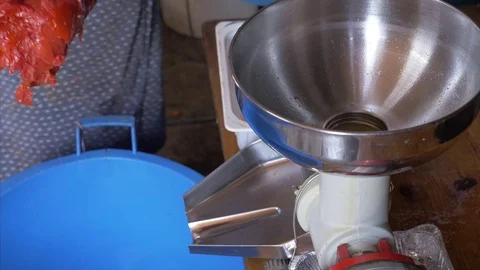 Put tomatoes in the machine for sauce preparation Stock Footage 78137575