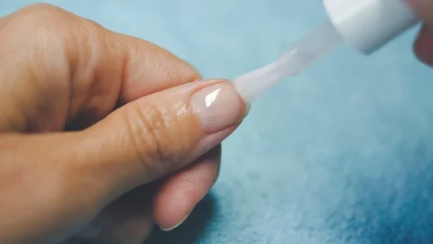 Put tranparent polish on five hand nails 1 Stock Footage 98739137