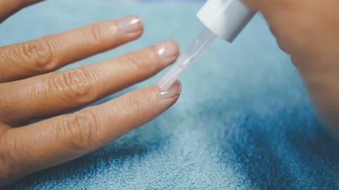Put tranparent polish on hand nails 1 Stock Footage 98739725